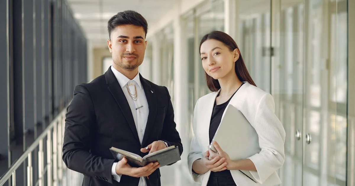 Female business professional receiving Pedrovazpaulo Executive Coaching from a confident coach in a modern office conference room.