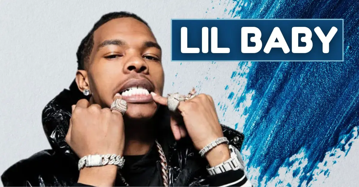 rapper Lil Baby in a close-up pose, highlighting his jewelry and style. He is displaying his diamond-studded grills while tugging on his lip with both hands. The background features a textured, blue abstract design with the text "LIL BABY" prominently displayed in bold white font against a dark blue rectangle